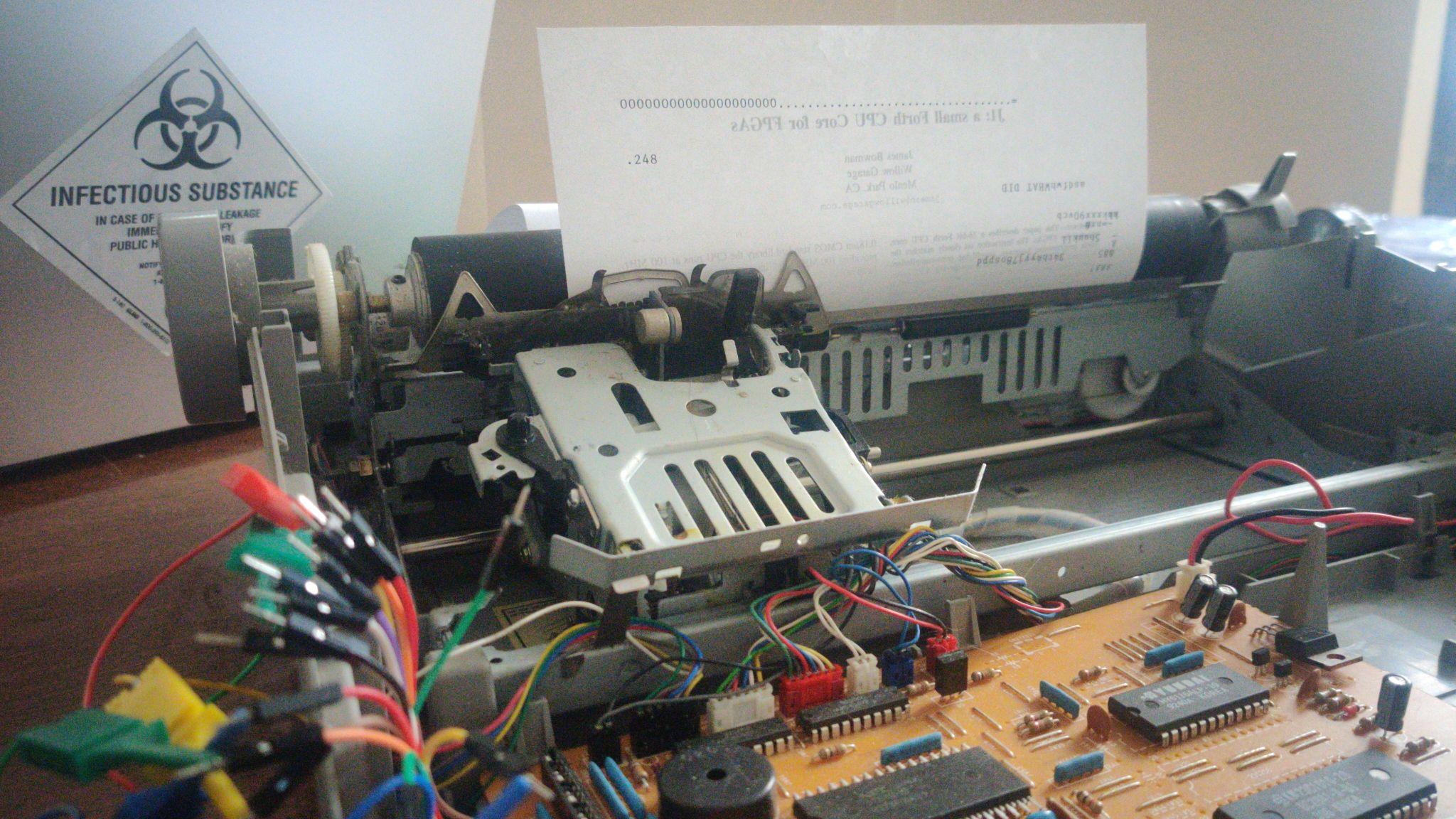 A disassembled electric typewriter with probing wires attached